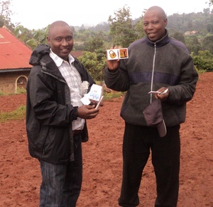 Ken Gatithi demostrating to Pastor James the gospel using the gift cube.